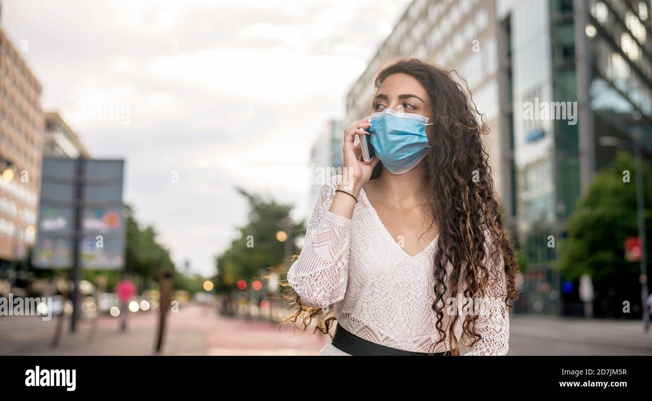 Woman wearing mask talking using hi-res stock photography and images ...