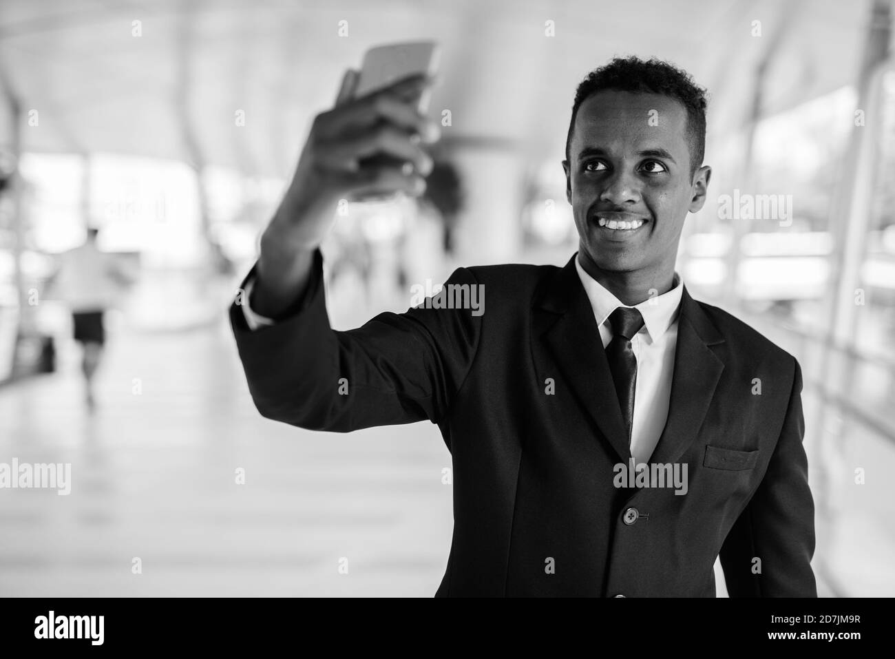 Young African businessman in suit exploring the city Stock Photo