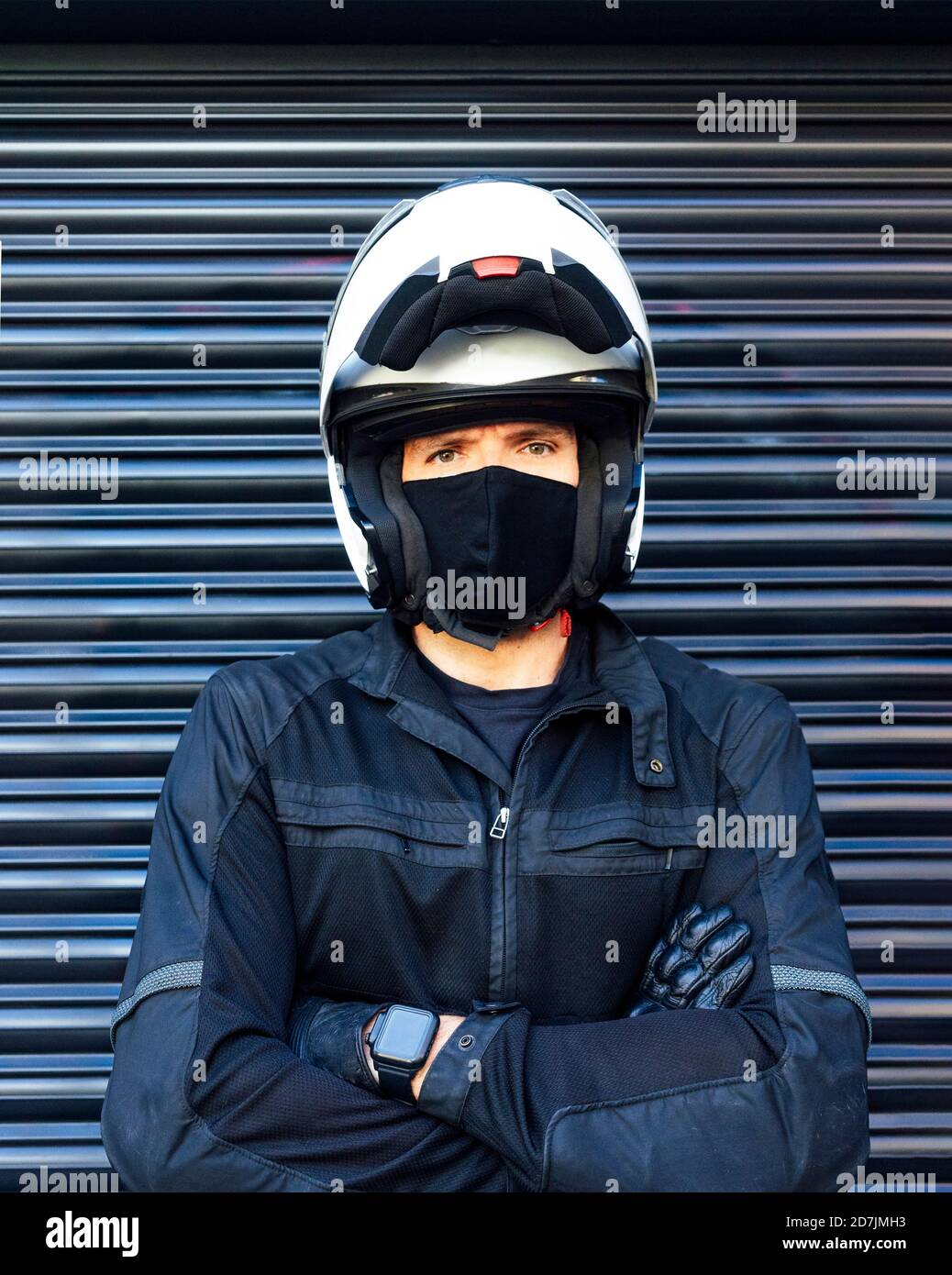 Portrait of male biker wearing helmet and protective face mask Stock Photo