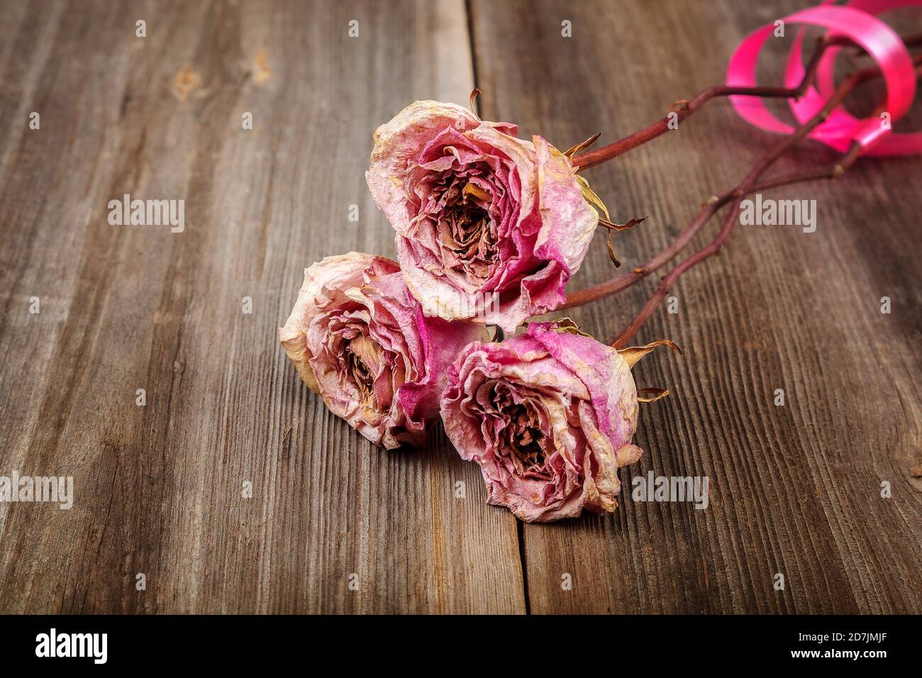 Dried flowers roses on a wooden background Stock Photo - Alamy
