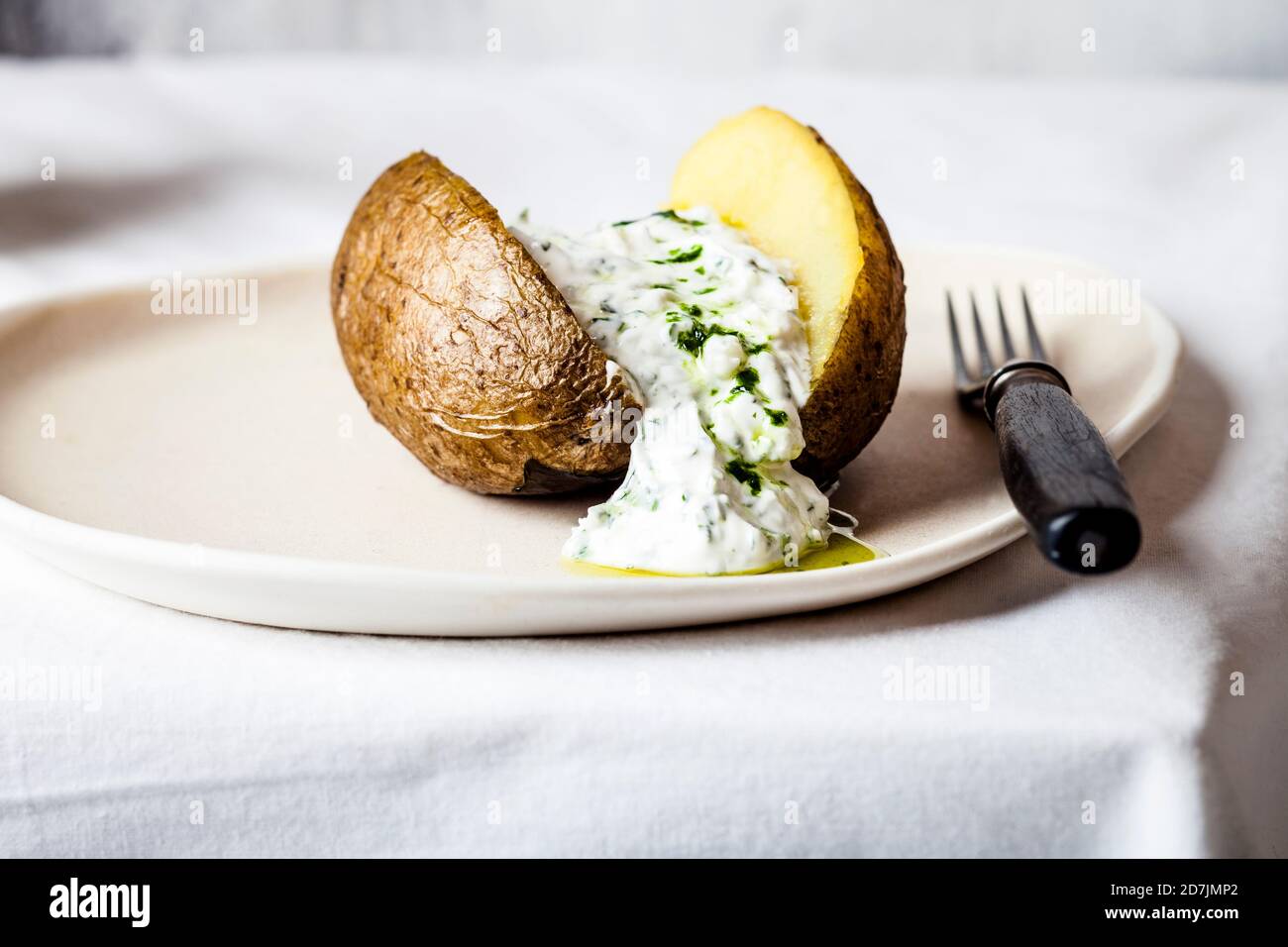 Baked potato with herb quark and homemade ramson oil Stock Photo Alamy
