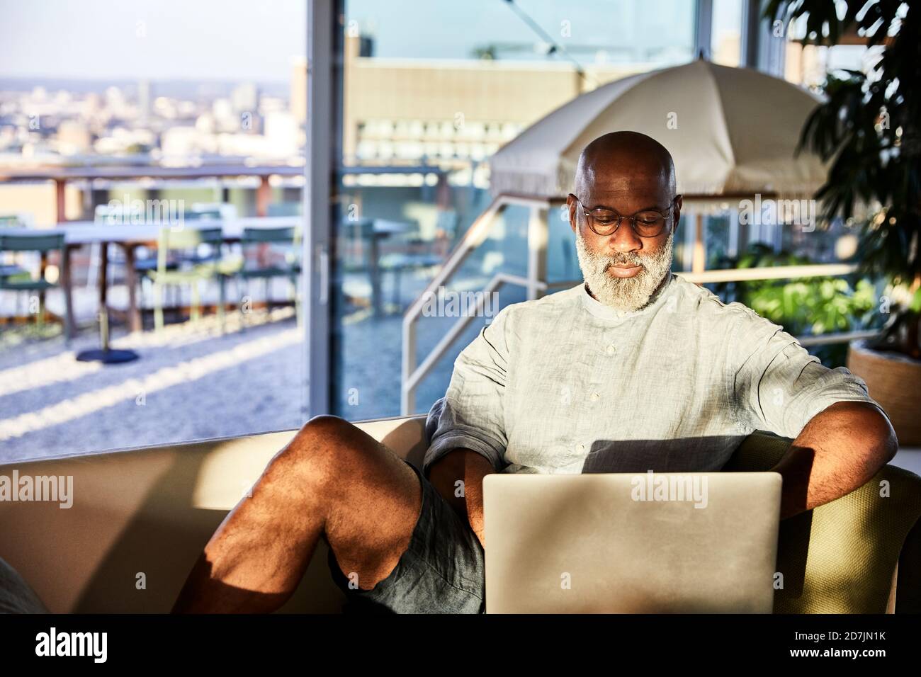 Mature man working from home while using laptop Stock Photo