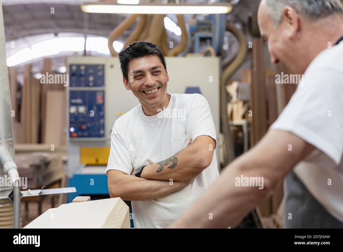 Smiling coworkers working together at workshop Stock Photo