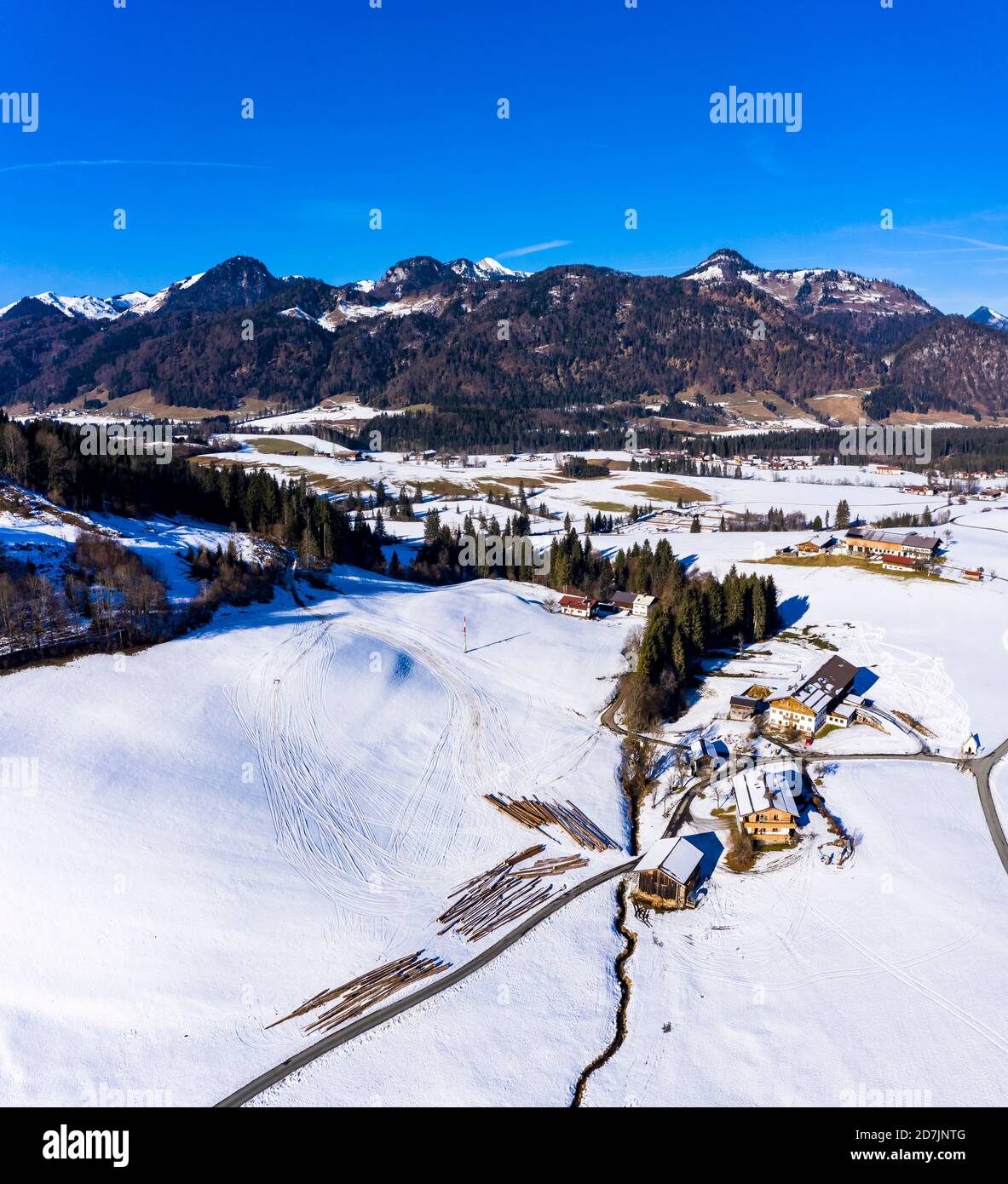 Austria, Tyrol, Kossen, Helicopter view of mountain village in snow-covered Leukental valley Stock Photo