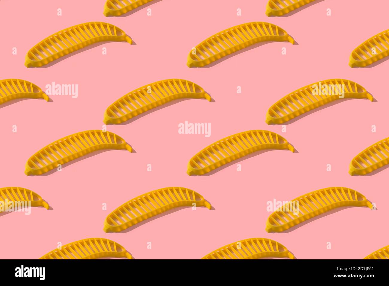 Banana slicer on pink background Stock Photo