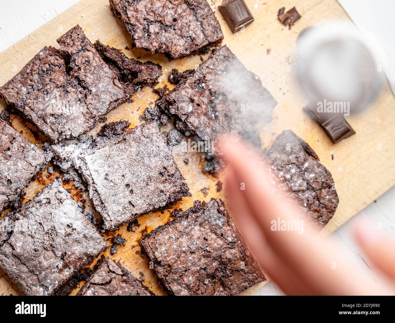 Overhead shot of freshly baked brownies dusted with powdered sugar