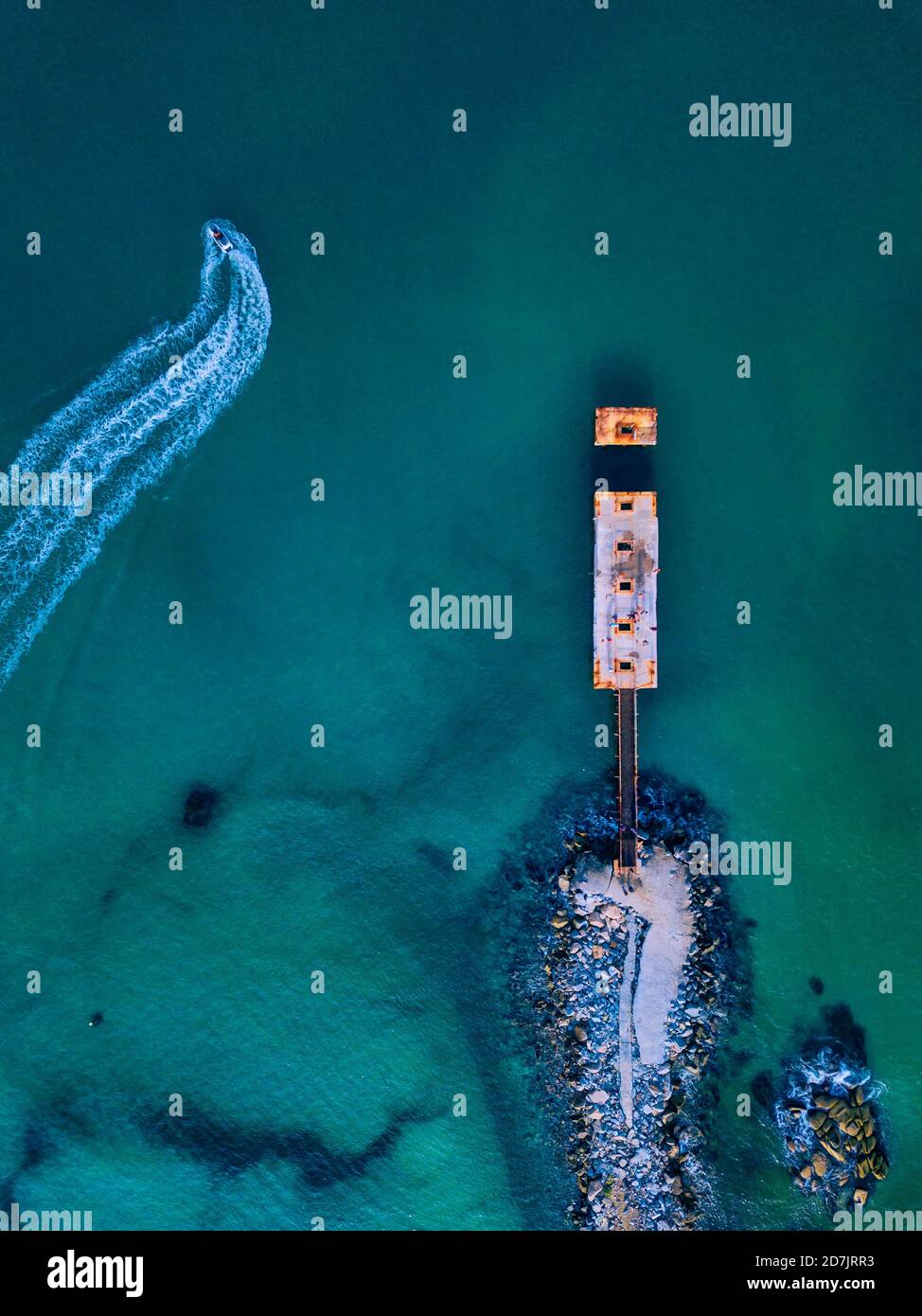 Aerial view of small pier and jet boat sailing in turquoise water Stock ...