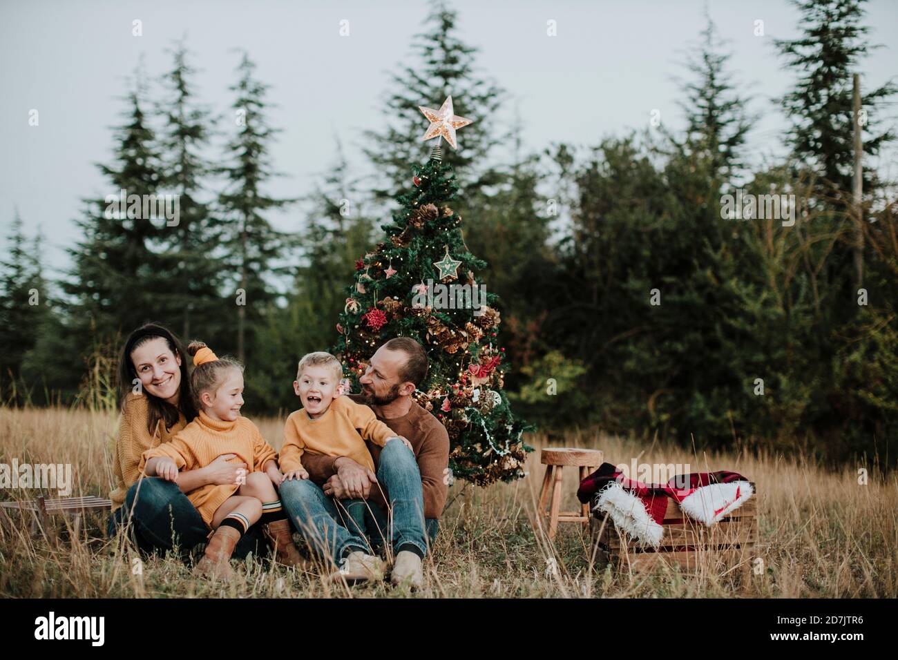 Family celebrating Christmas at countryside during sunset Stock Photo