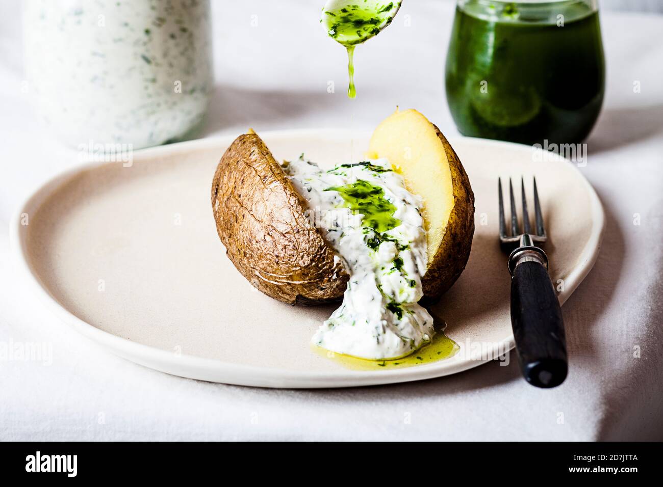 Baked potato with herb quark and homemade ramson oil Stock Photo Alamy
