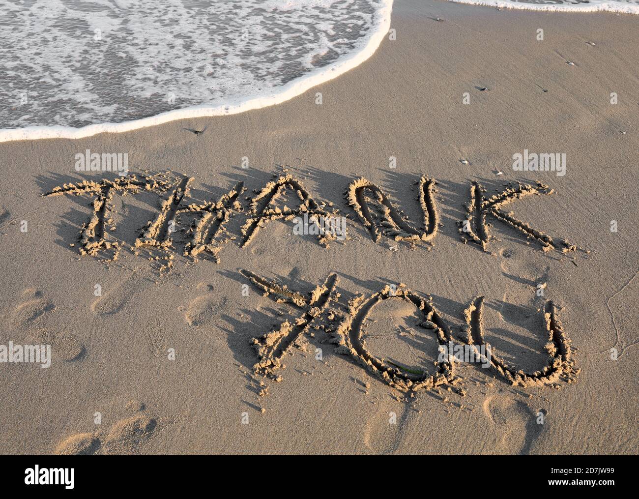 Big Text THANK YOU on the sand of the beach Stock Photo - Alamy