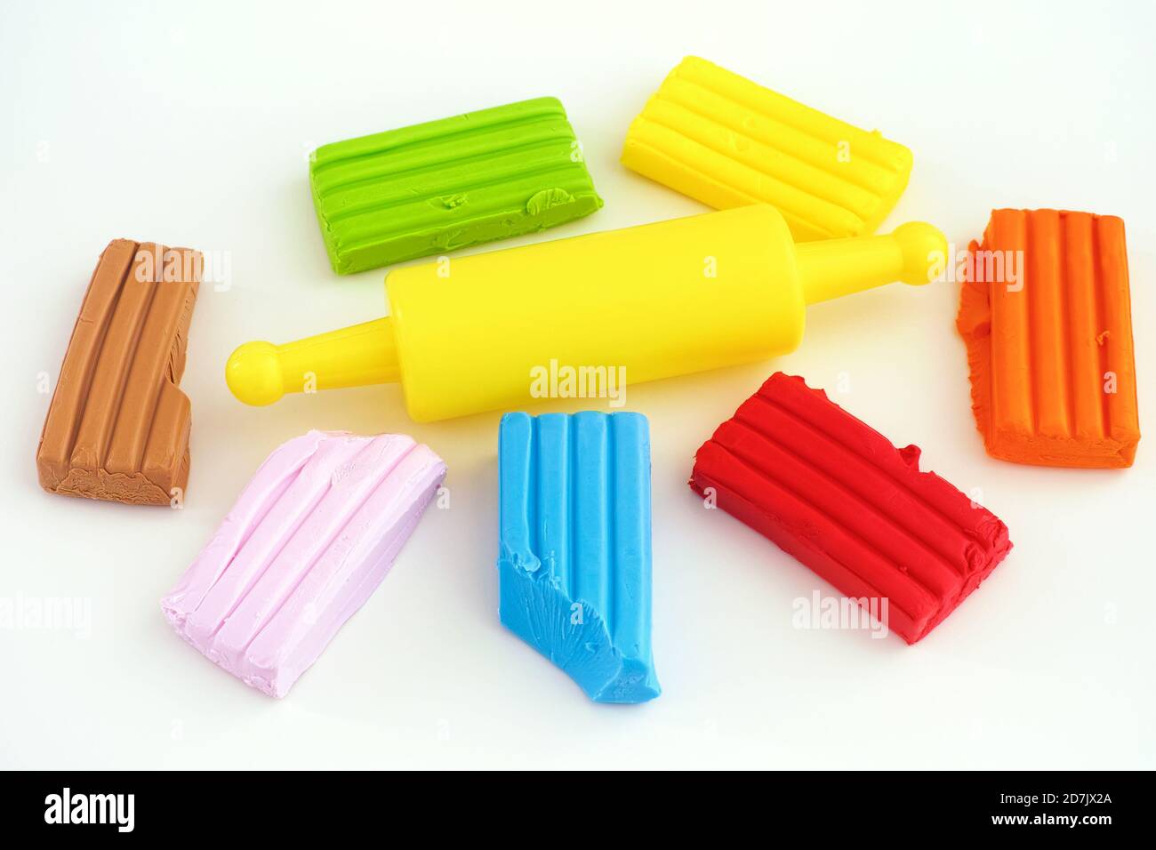 Colorful polymer clay and rolling pin. Close up. Stock Photo