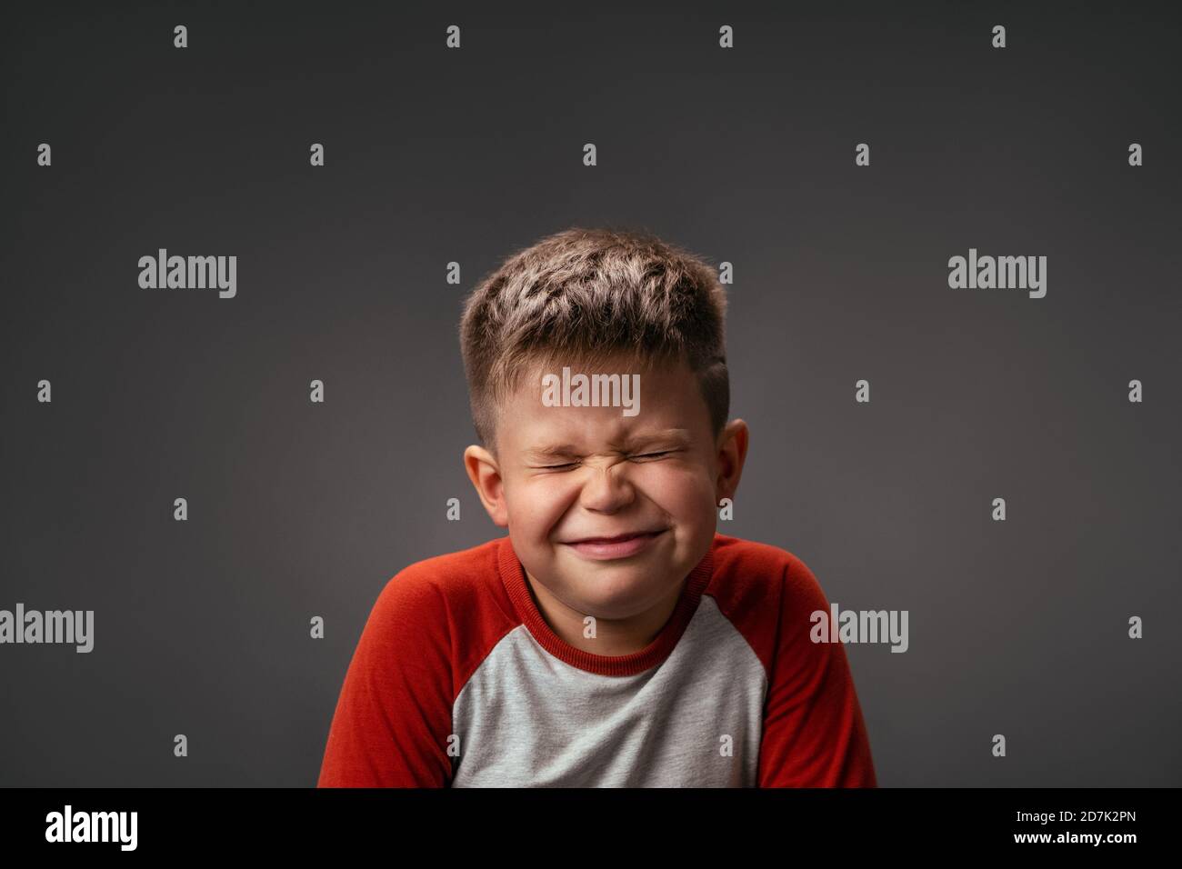Funny boy smiles closed eyes. Isolated on gray background. Birthday ...