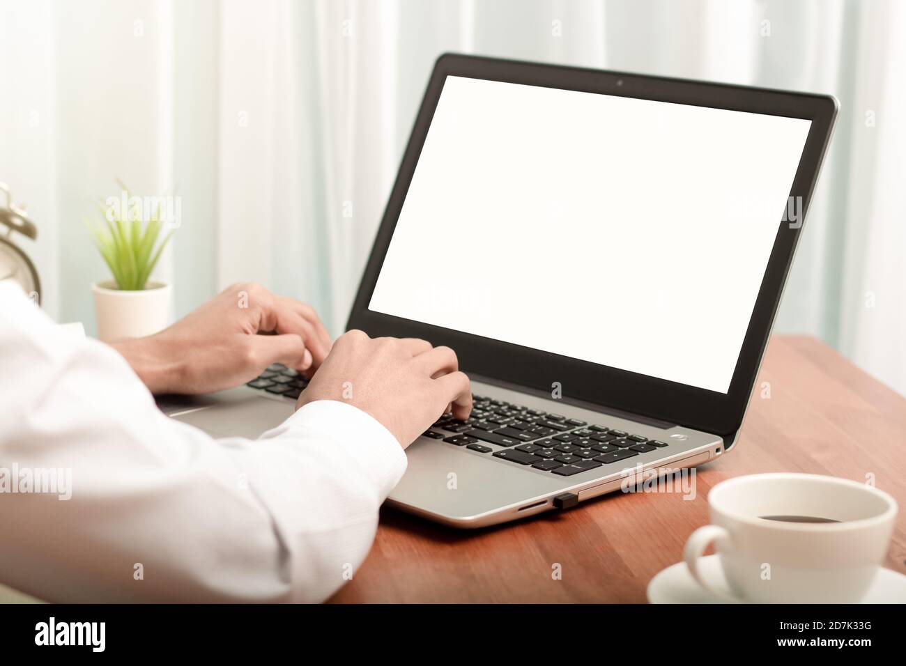Business man working on laptop computer at home while sitting the wooden table.Male hands typing on the notebook keyboard.Online shopping,Working from Stock Photo