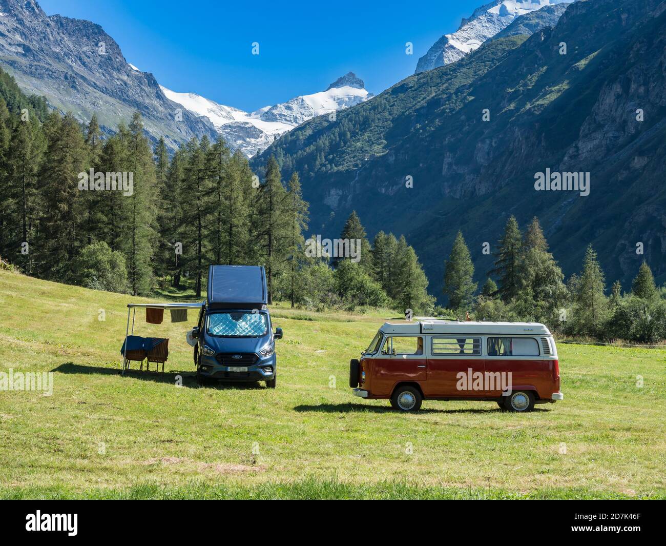 Camper vans on a small campsite, modern campervan and old VW bus, village  Zinal, mountain range in the back, Val d'Anniviers, Switzerland Stock Photo  - Alamy