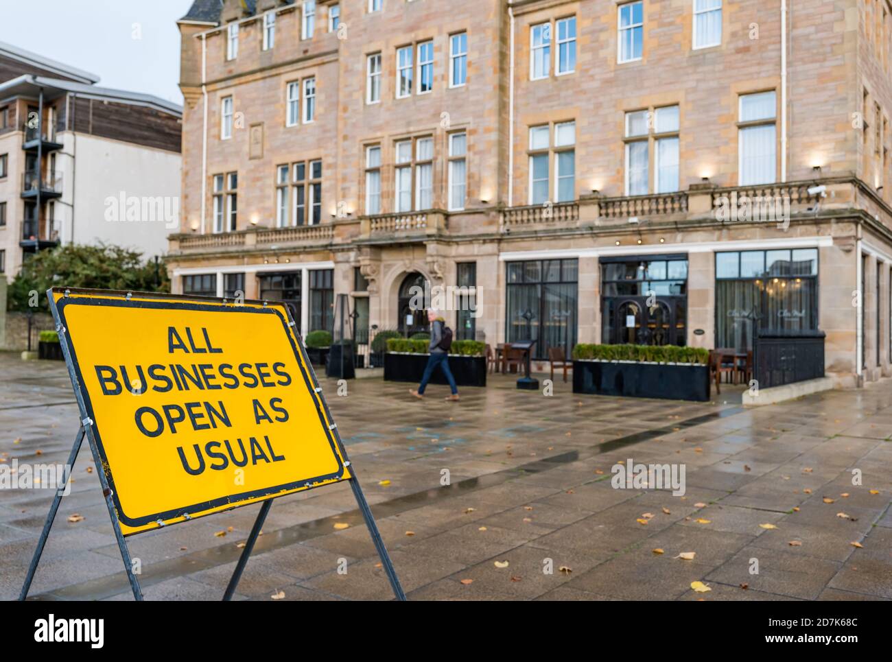 The Shore, Leith, Edinburgh, Scotland, United Kingdom, 23rd October 2020. Bars & restaurants: many restaurants are closed as the Scottish Government extends restrictions during the Covid-19 pandemic for a 3rd week, but many are still open serving takeaway food and beer. The Malmaison Hotel's Chez Mal restaurant is only open to hotel guests. There is some irony with the Trams to Newhaven 'All Businesses Open as Usual' sign nearby Stock Photo