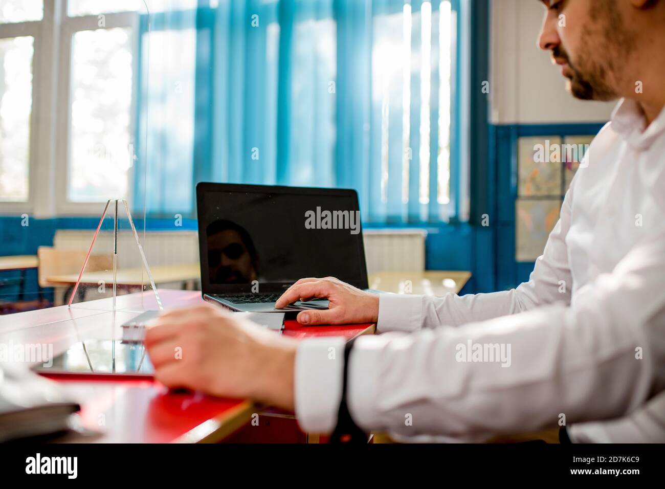 Professor in classroom using laptop and digital tablet Stock Photo - Alamy
