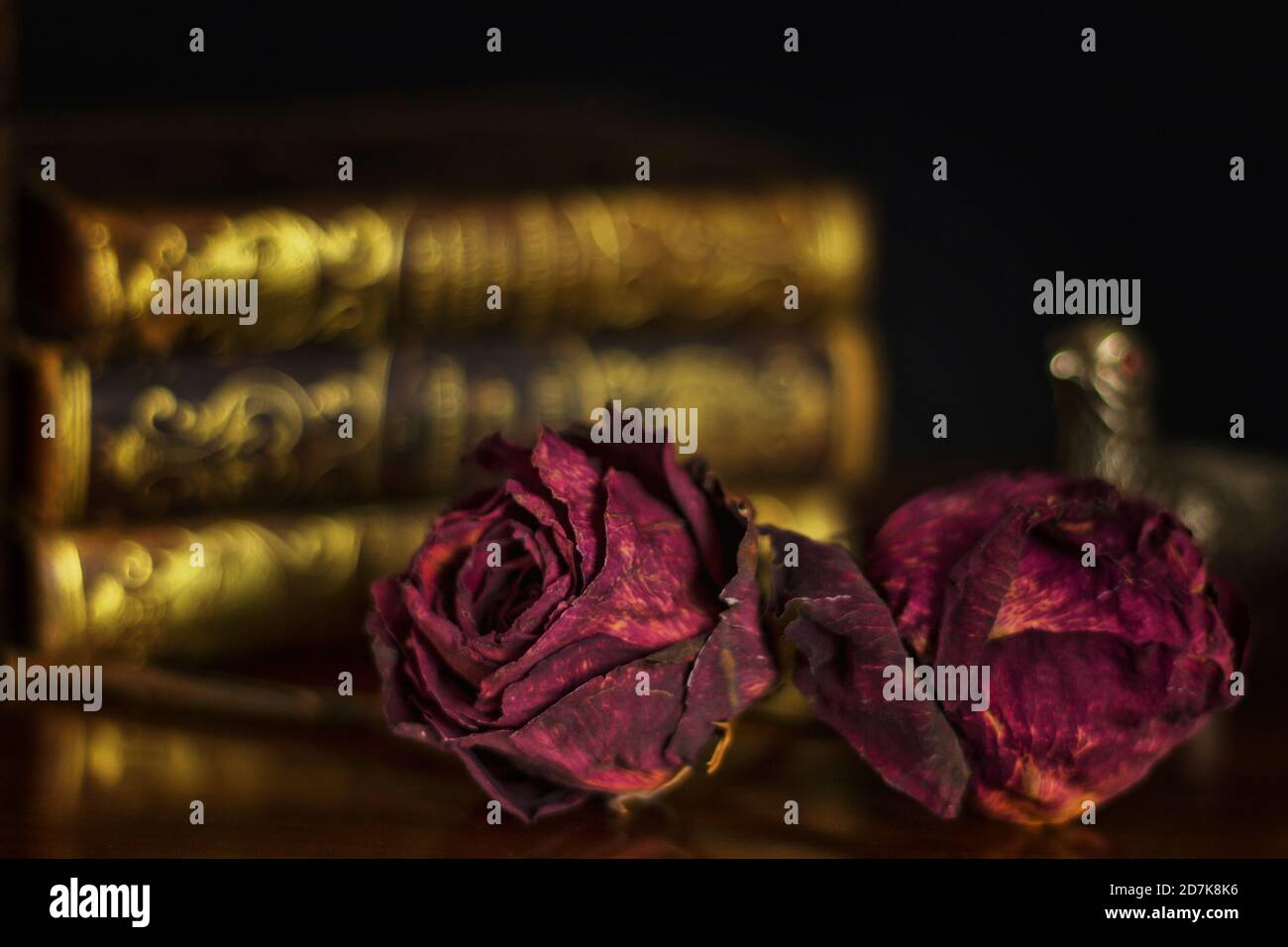 Still life of dried rose flowers with old books Stock Photo - Alamy