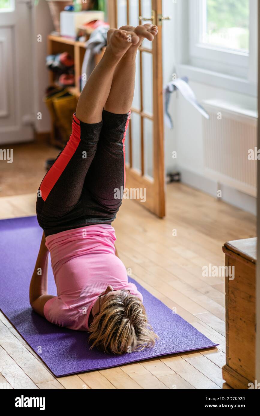 Woman doing an upside down yoga pose Stock Photo Alamy