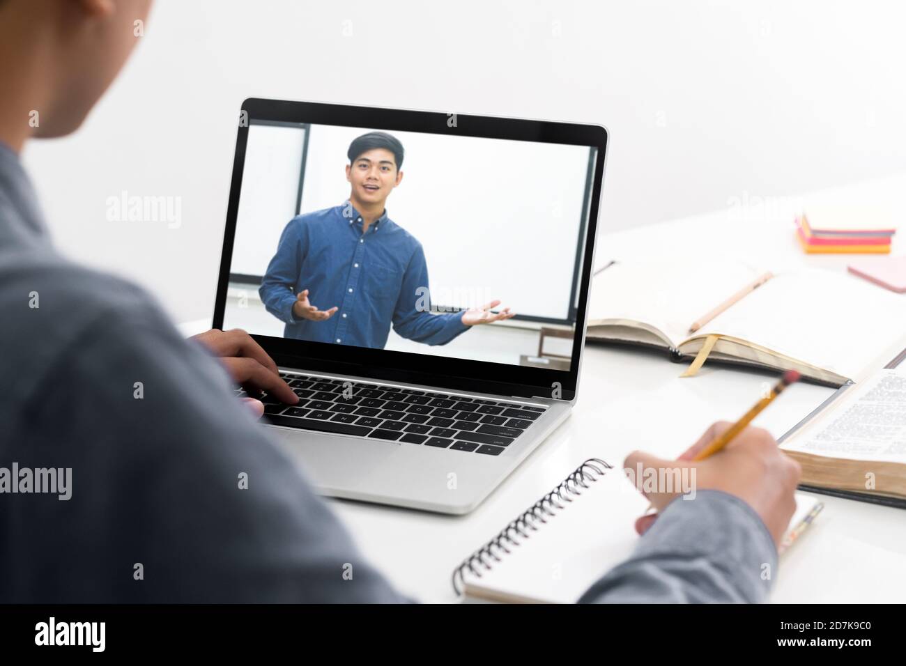 Young collage student using computer and mobile device studying online. Education and online learning. Stock Photo