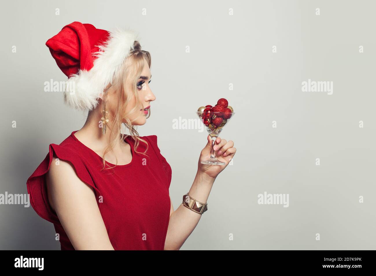 Elegant Christmas woman in Santa hat on 