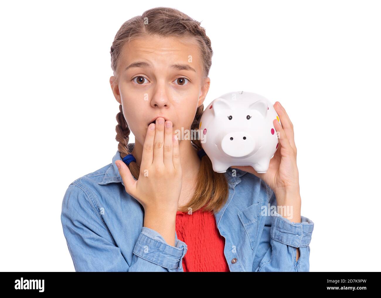 Beautiful teenage girl holds a piggy bank in her hands, isolated on ...