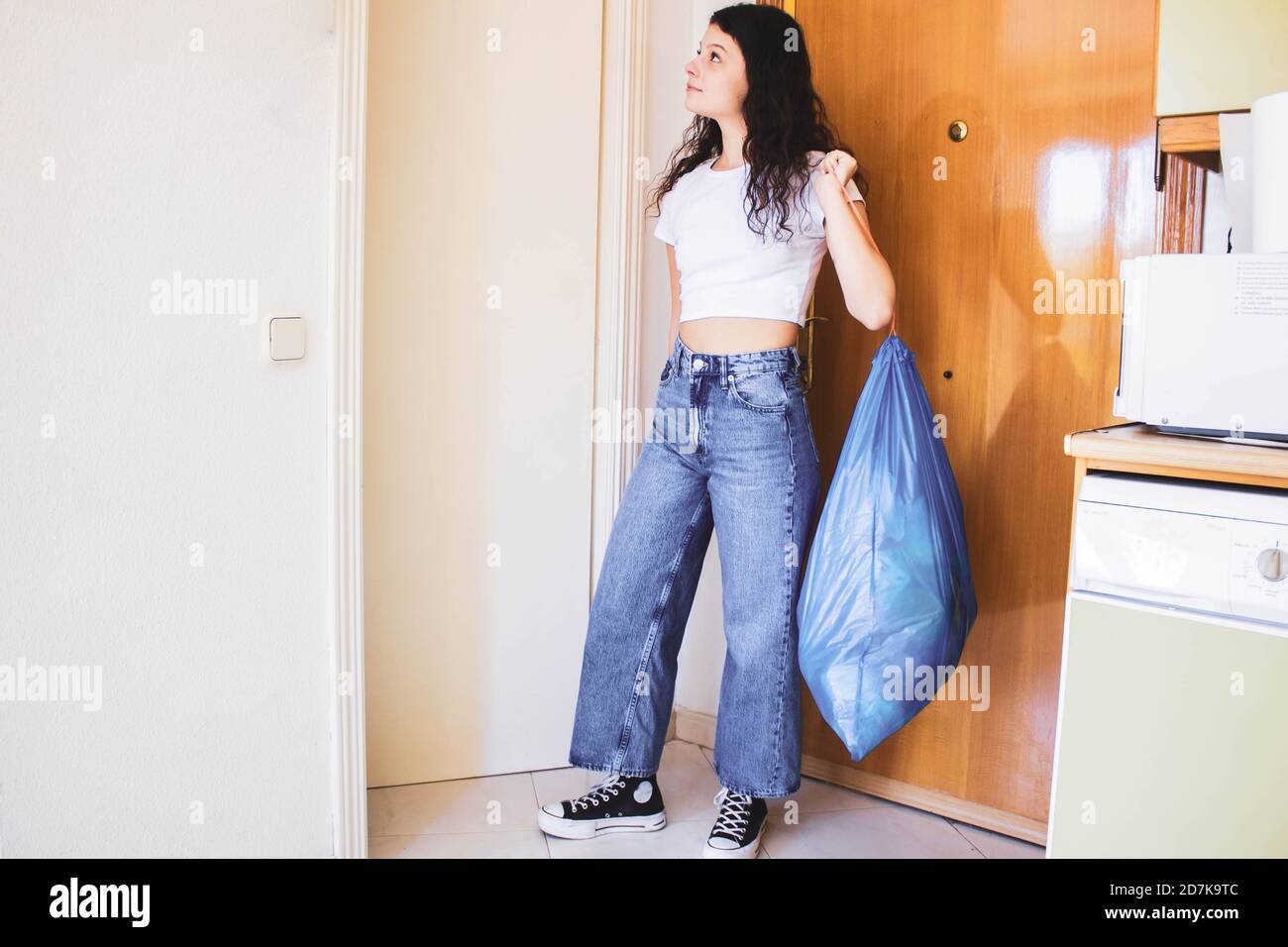 girl throwing garbage at the front door Stock Photo Alamy