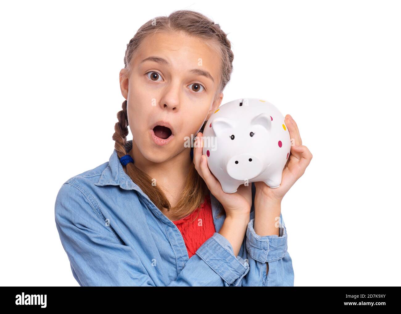 Beautiful teenage girl holds a piggy bank in her hands, isolated on ...