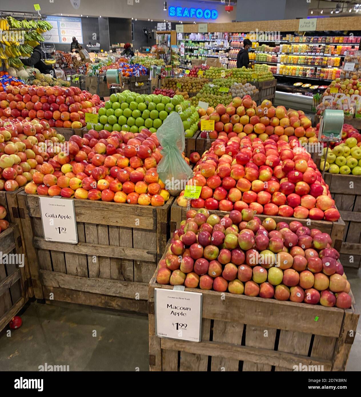 Large crates of various varieties of fresh apples for sale at a Whole Foods store in New York City. Stock Photo