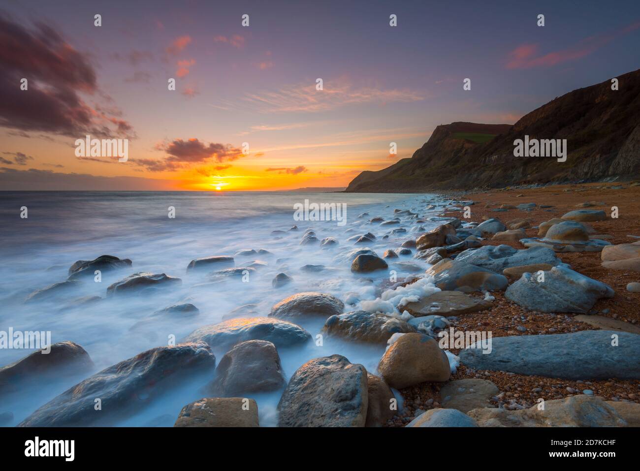 Eype, Dorset, UK.  23rd October 2020.  UK Weather.  Sunset at Eype beach near Bridport in Dorset looking towards the cliffs of Thorncombe Beacon.  Picture Credit: Graham Hunt/Alamy Live News Stock Photo