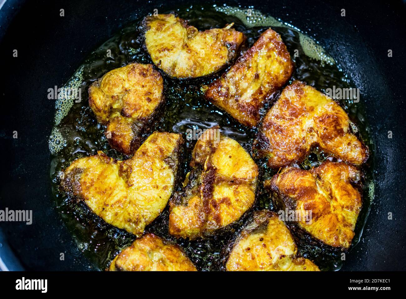 Deep frying cut fish in low flame looking delicious Stock Photo Alamy