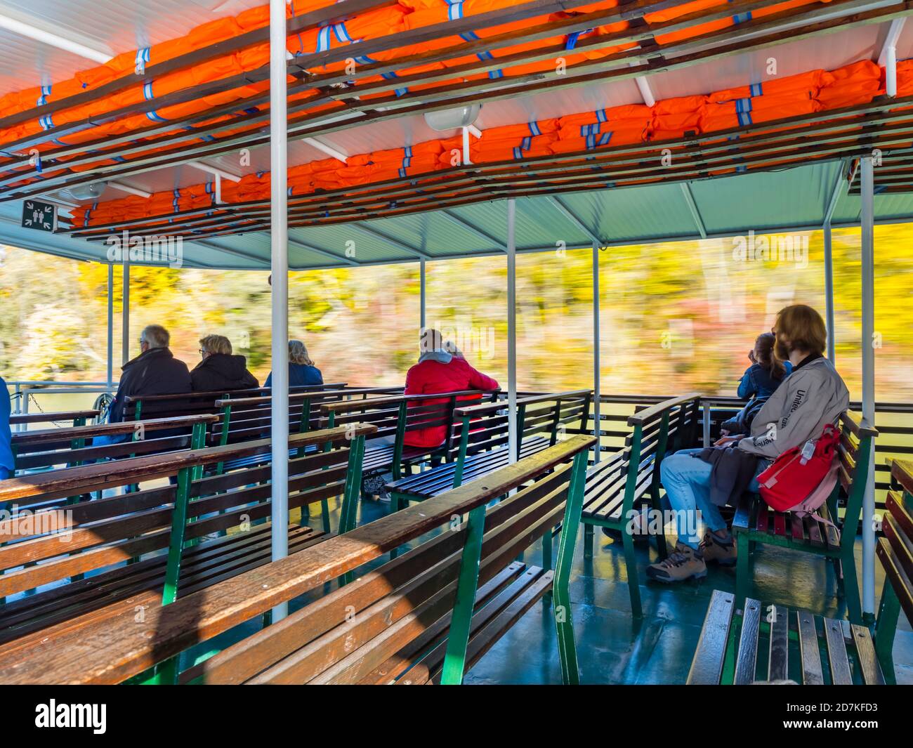 Lake passenger boat passenger visitors sitting watching vegetation passing by blurry portraying speed movement in Plitvice lakes in Croatia Europe Stock Photo