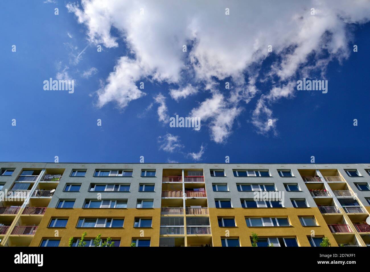 Upward view of the concrete residential building. Building and sky with clouds. Stock Photo