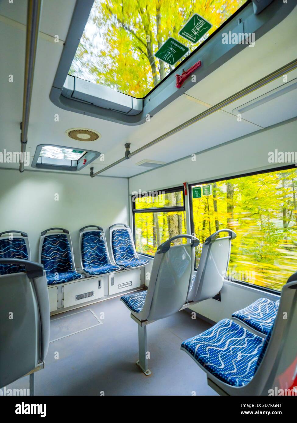 Empty seats seating seat in train vehicle cabin interior inside blurry exterior passing by portraying speed in Plitvice lakes in Croatia Europe Stock Photo