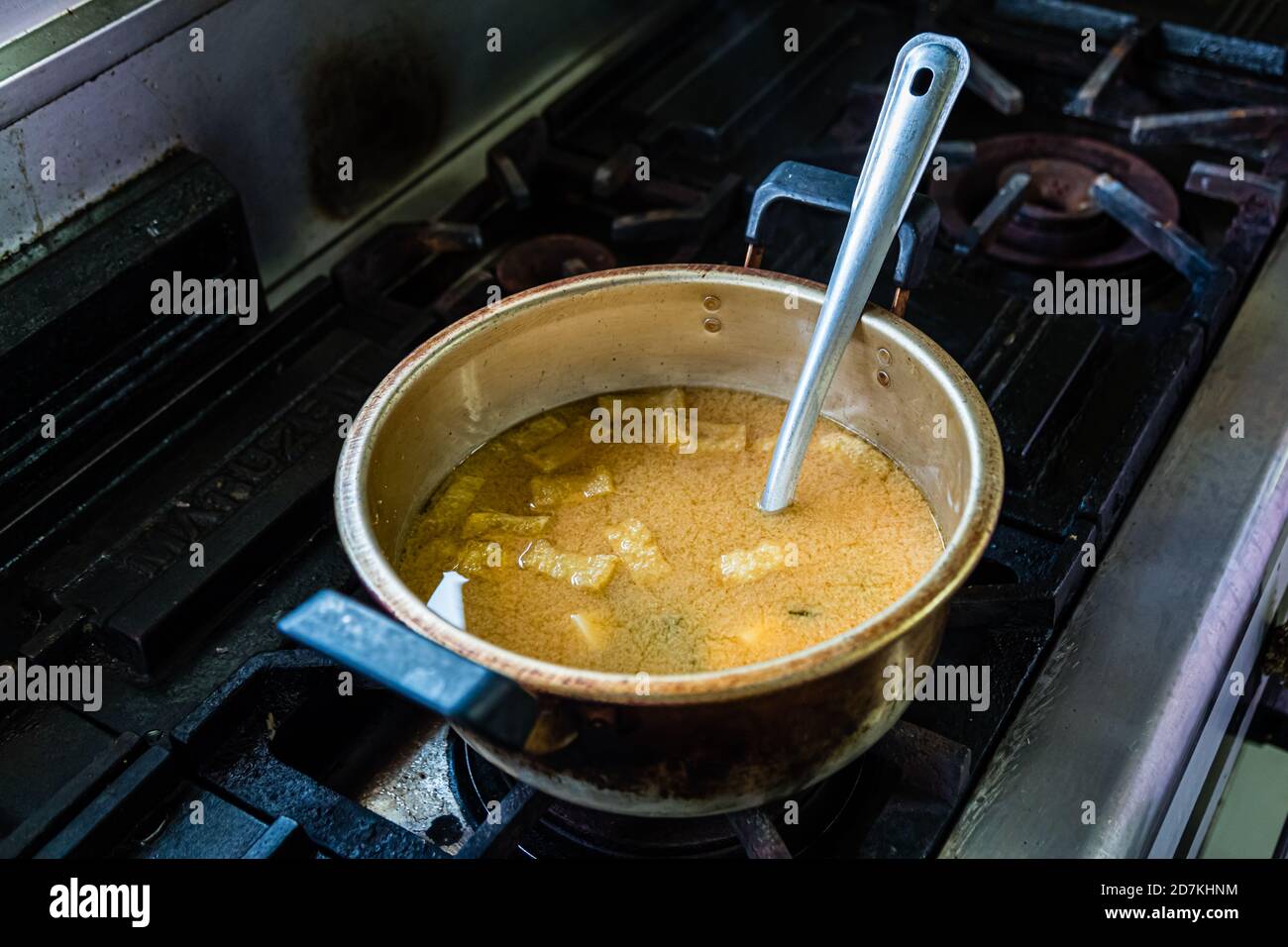 Making a Japanese miso soup in Nishiizu, Japan. Never bring miso soup to a boil, as this would add to the beneficial bacteria. But stir again just before serving Stock Photo