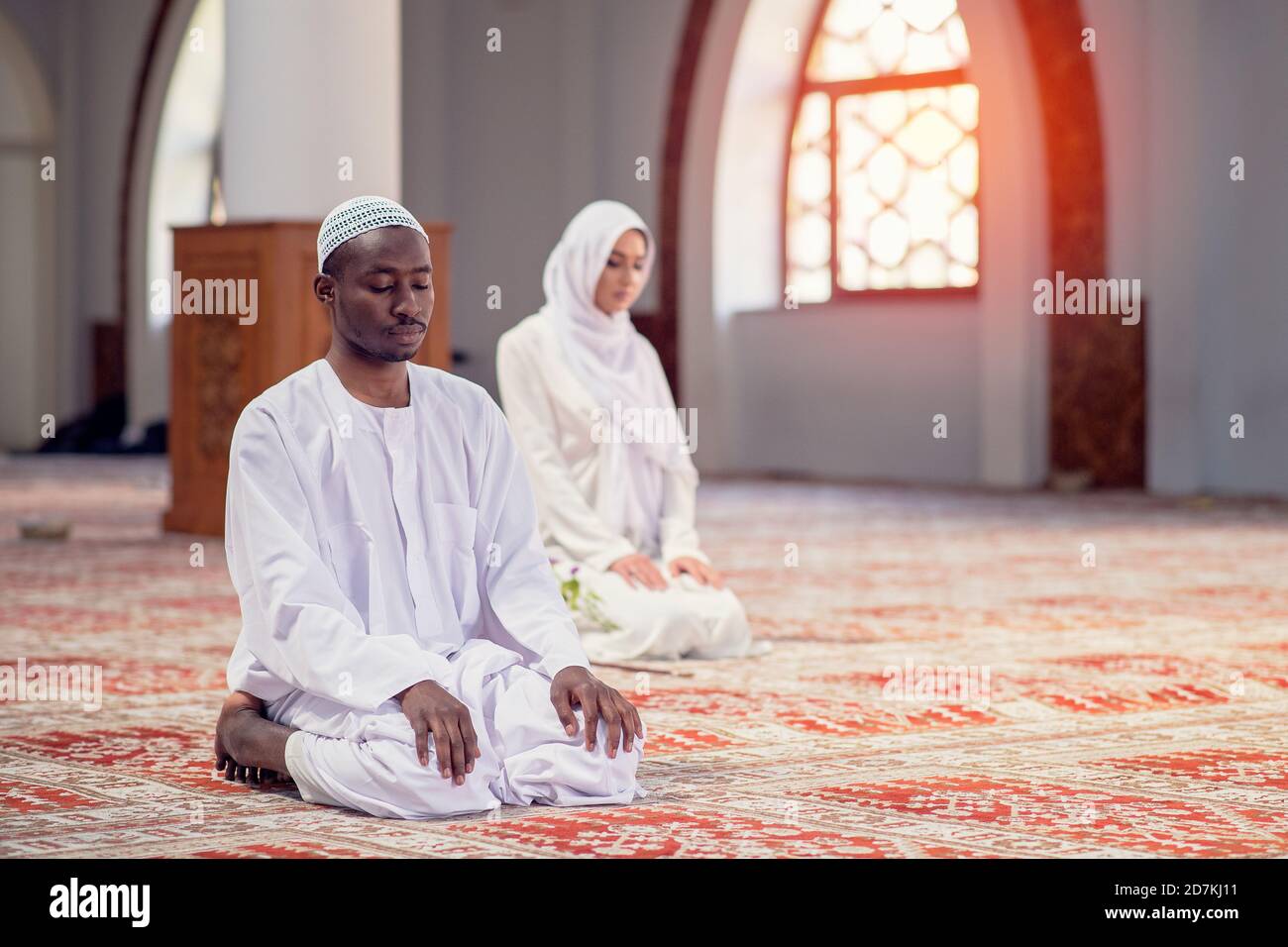 African Muslim Couple Praying inside of beutiful mosque Stock ...