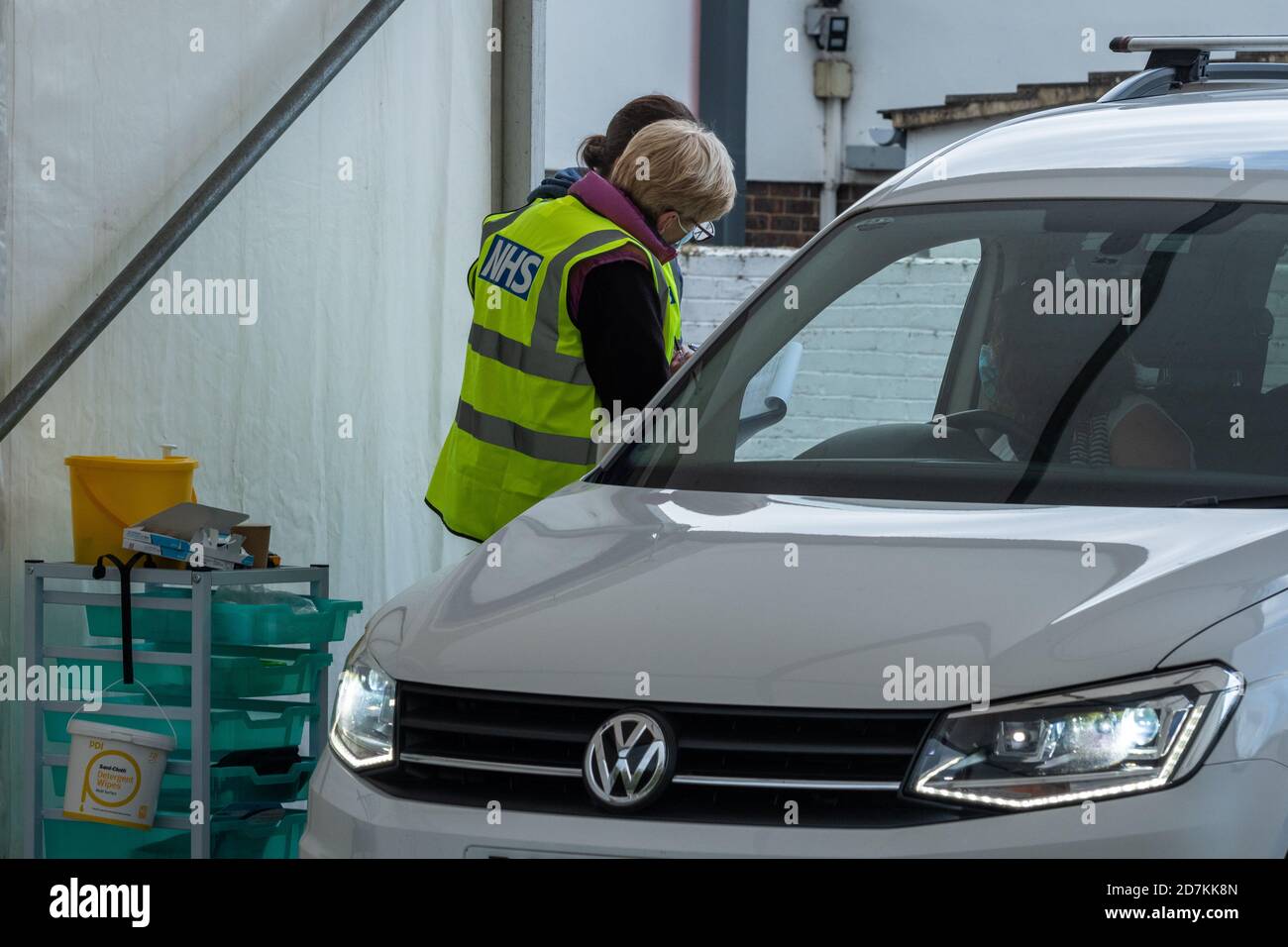 NHS drive through flu clinic providing influenza jabs vaccinations immunizations, Surrey, UK Stock Photo