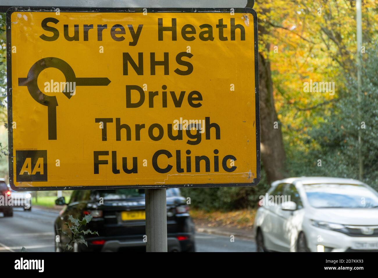 Road sign to an NHS drive through flu clinic providing influenza jabs vaccinations immunizations, Surrey, UK Stock Photo