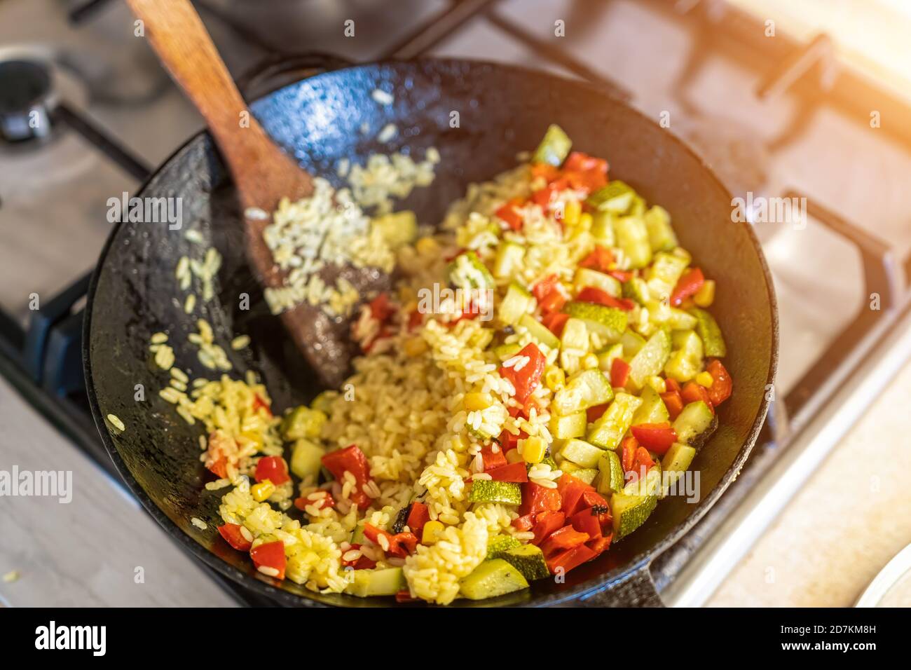 a big pilaf pan bowl with mix of vegetables , cooking on the kitchen. rice with red beans and vegetables in a frying pan Stock Photo