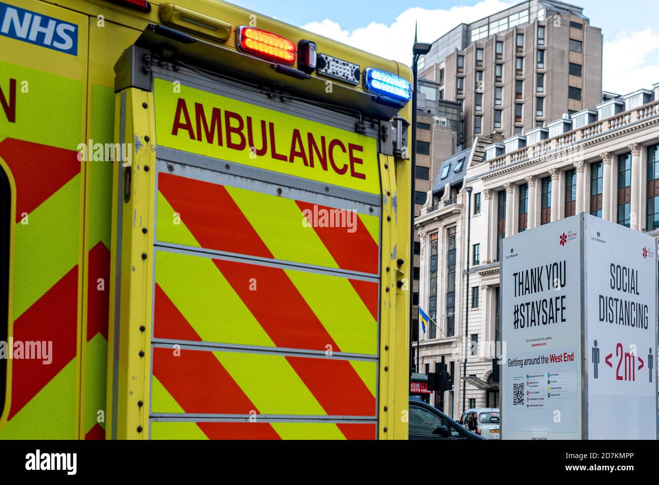 London, United Kingdom- October 22 2020: Social Distancing Sign in background with the back of an UK Ambulance parked next to it. London is... Stock Photo