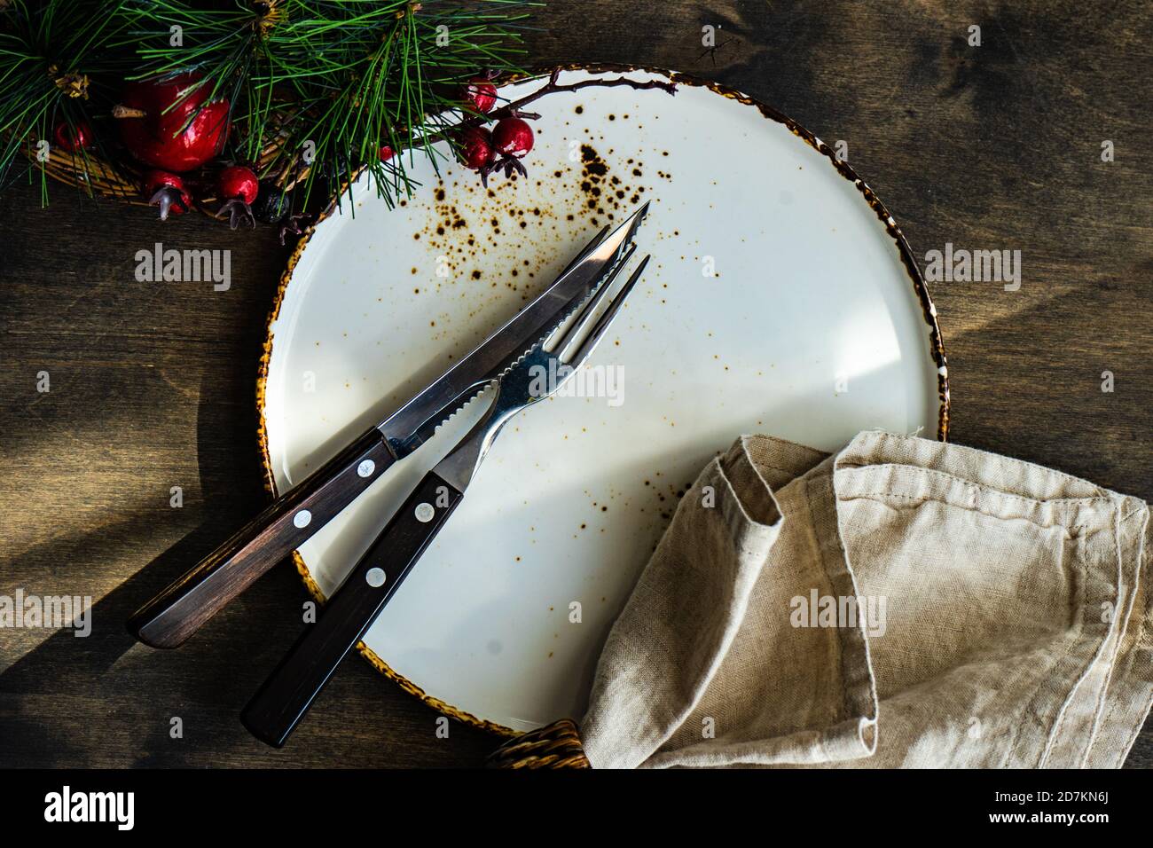 Minimalistic table setting for Christmas dinner on wooden table Stock Photo