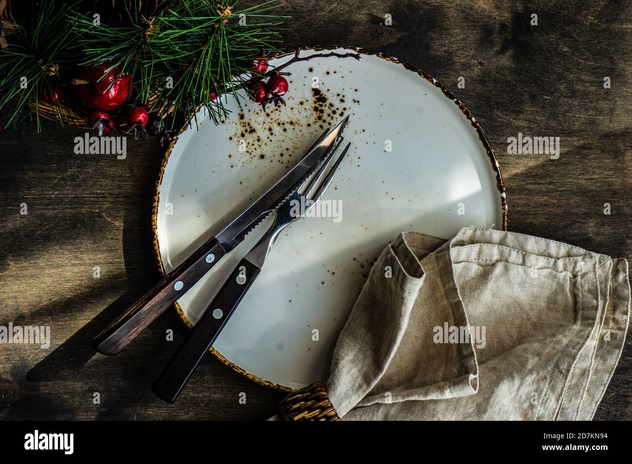 Minimalistic table setting for Christmas dinner on wooden table Stock Photo