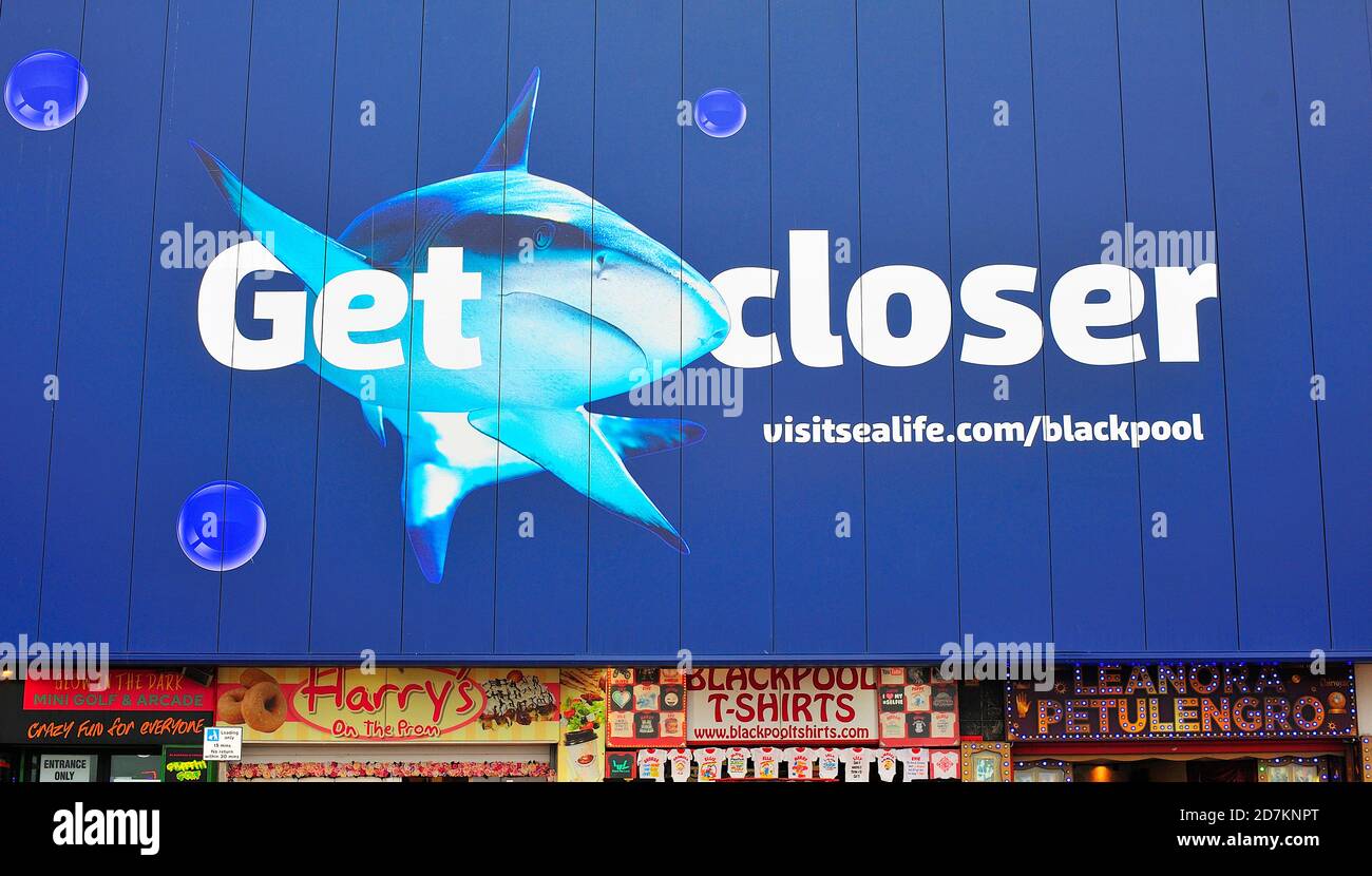 Row of tourist shops below Sealife Centre sign on Blackpool Promenade