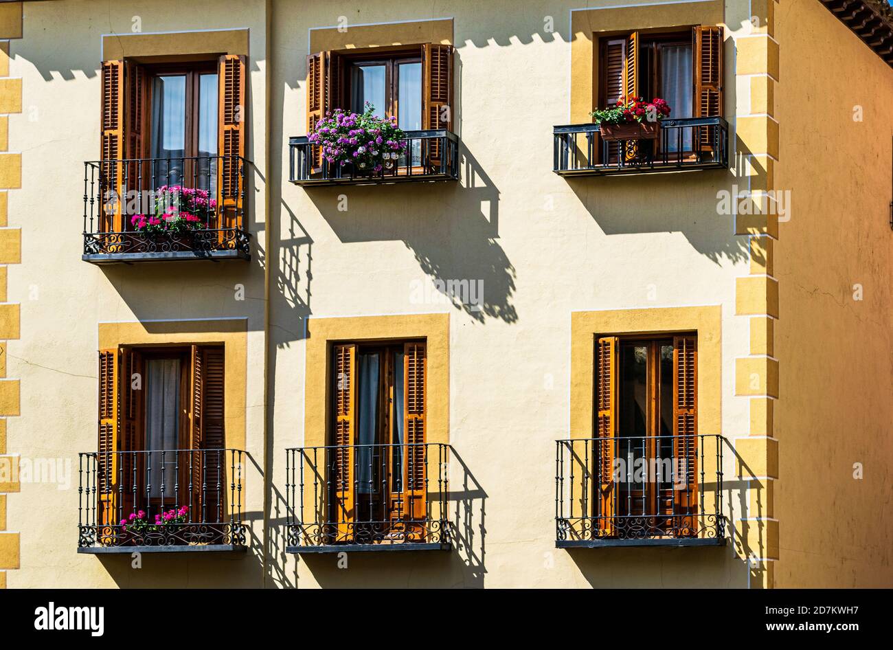 Colorful window boxes against building with yellow and gold tones in