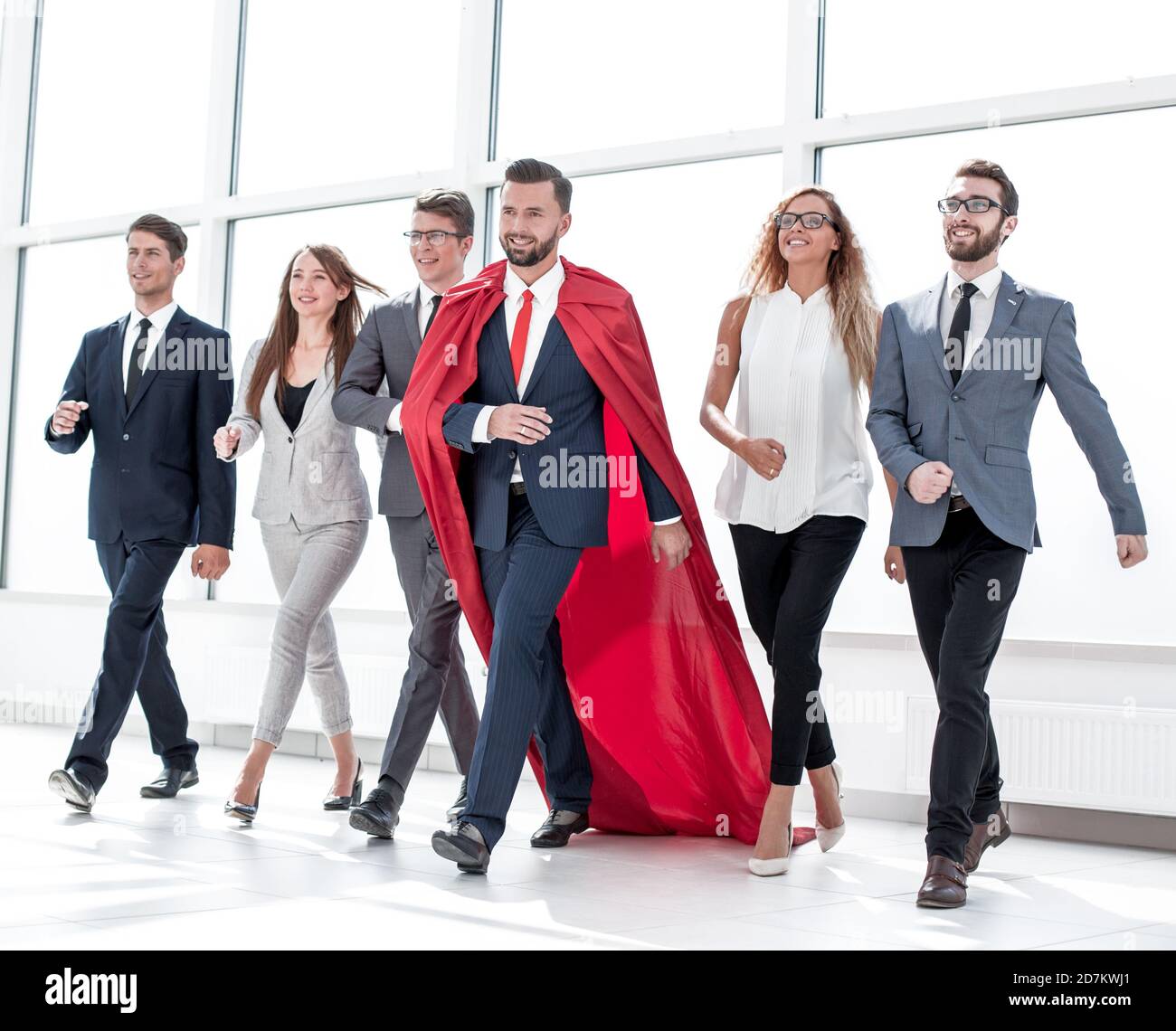 businessman in a red cloak marching with the business team Stock Photo ...
