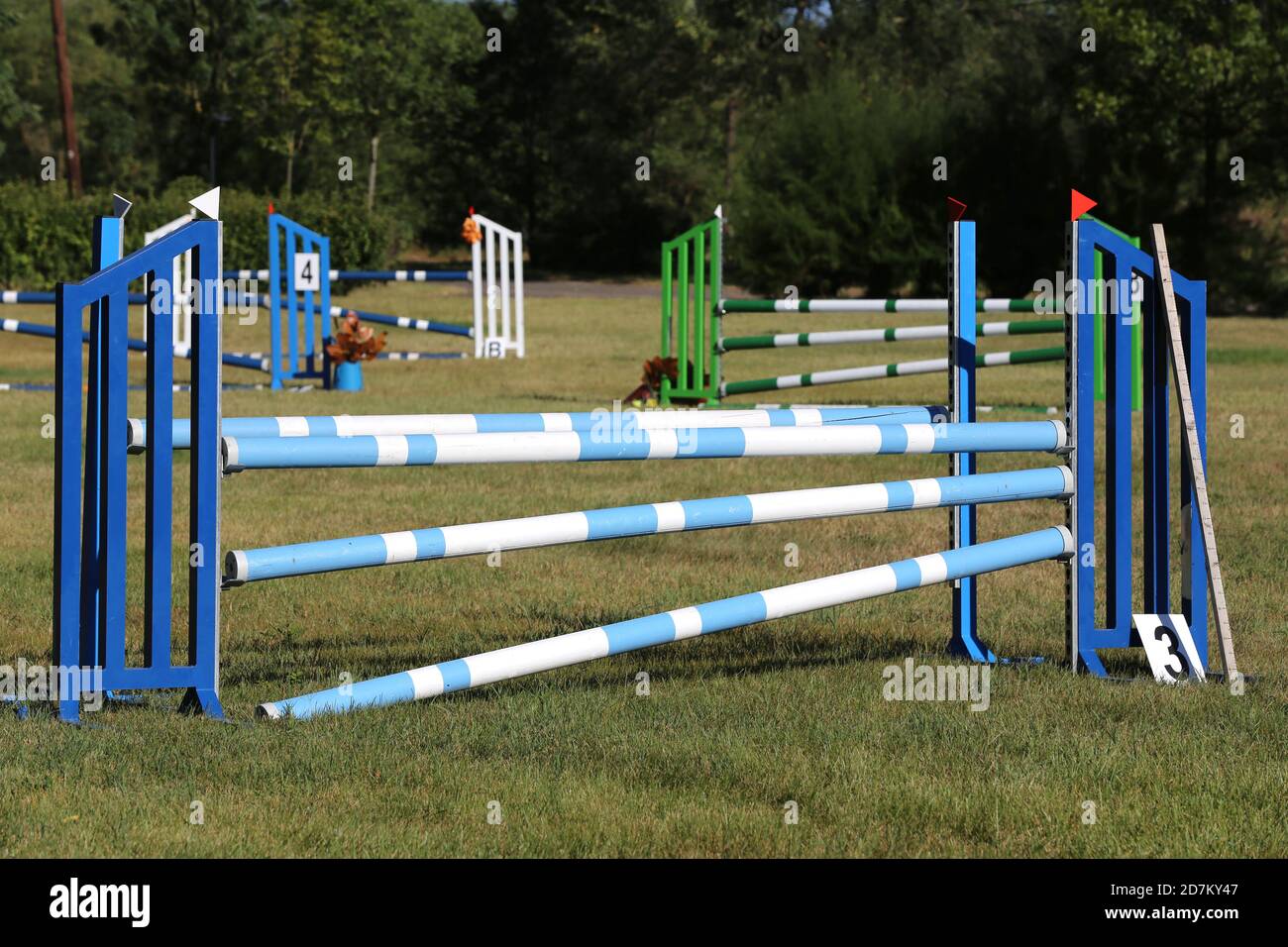 Colorful image of show jumping poles at an open air show jumping arena