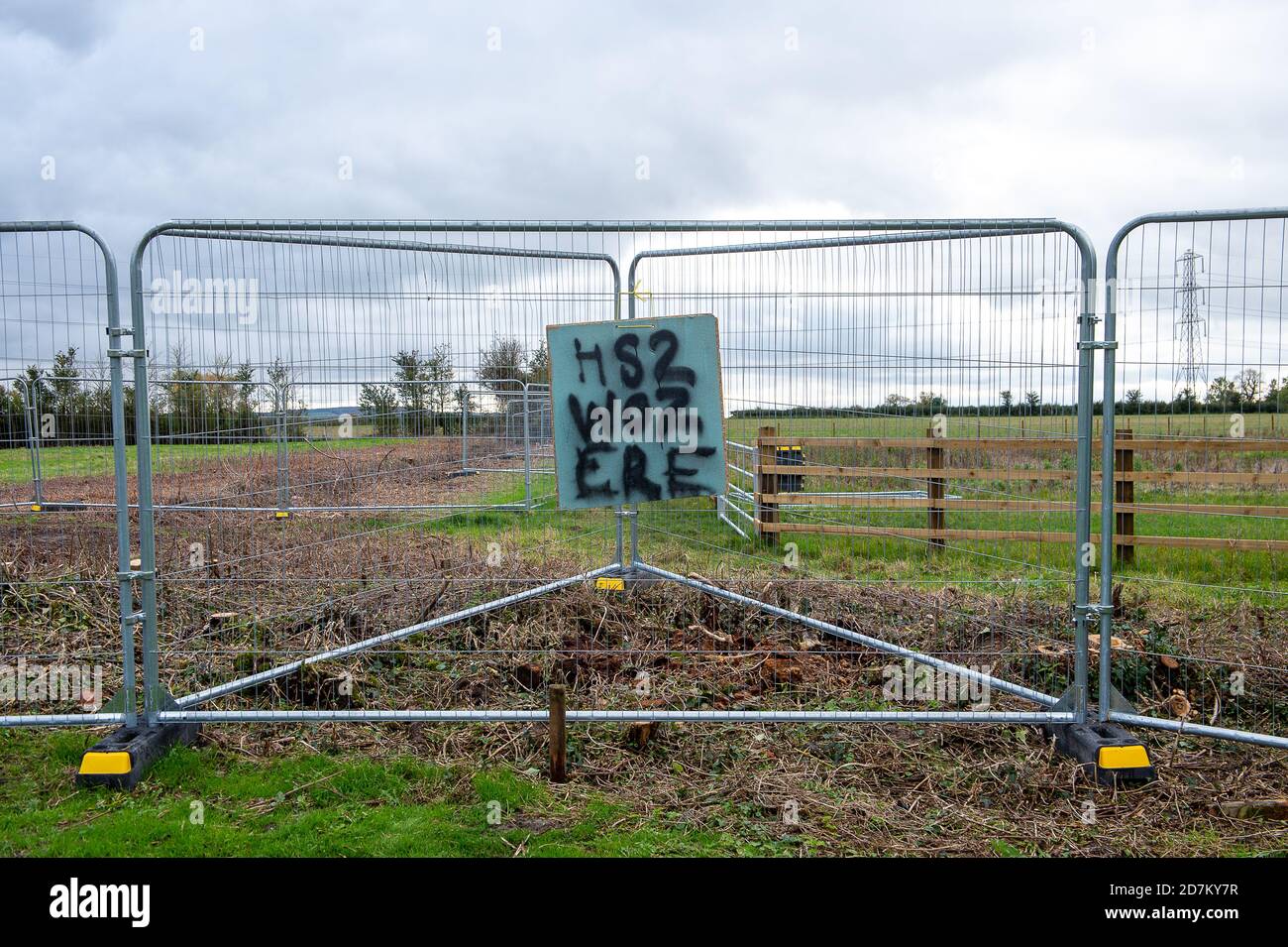 Stoke Mandeville, Buckinghamshire, UK. 23rd October 2020. Fusion JV contractors working on behalf of HS2 on the High Speed Rail link, have cut down a hedgerow at the Bucks Goat Centre allegedly trespassing on their land and without prior permission or consultation. HS2 did this signs now hang on the HS2 high security fences on the perimeter of the Goat Centre. A temporary haul road is being built for the construction of the controversial and hugely over budget High Speed Rail from London to Birmingham which will pass through Stoke Mandeville. Credit: Maureen McLean/Alamy Live News Stock Photo