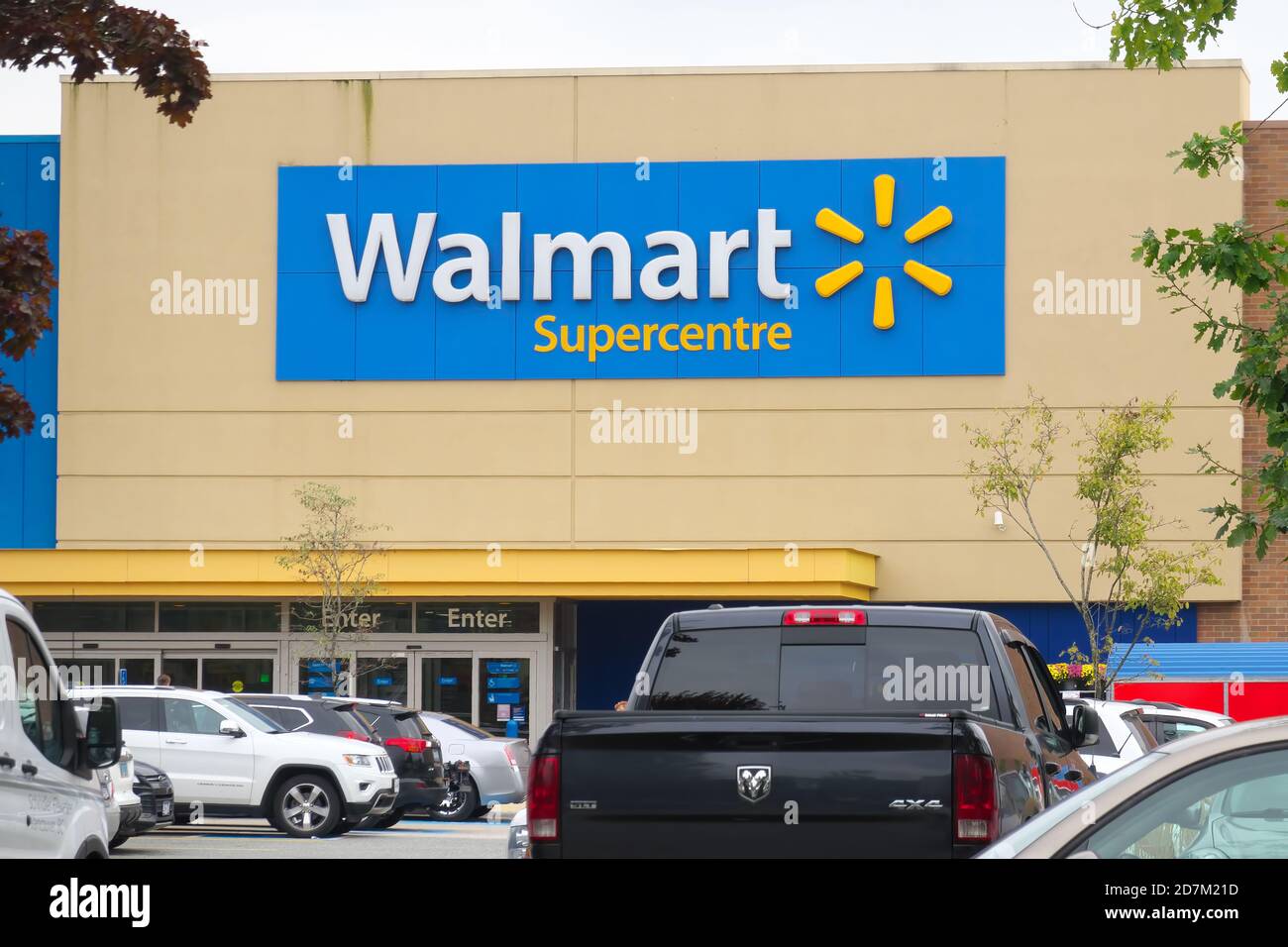 Storefront of Walmart Supercentre with cars in the parking lot. Maple