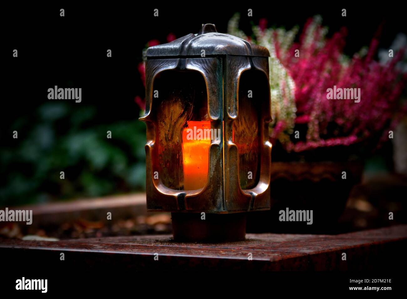 Grave lantern made of metal with burning candle Stock Photo