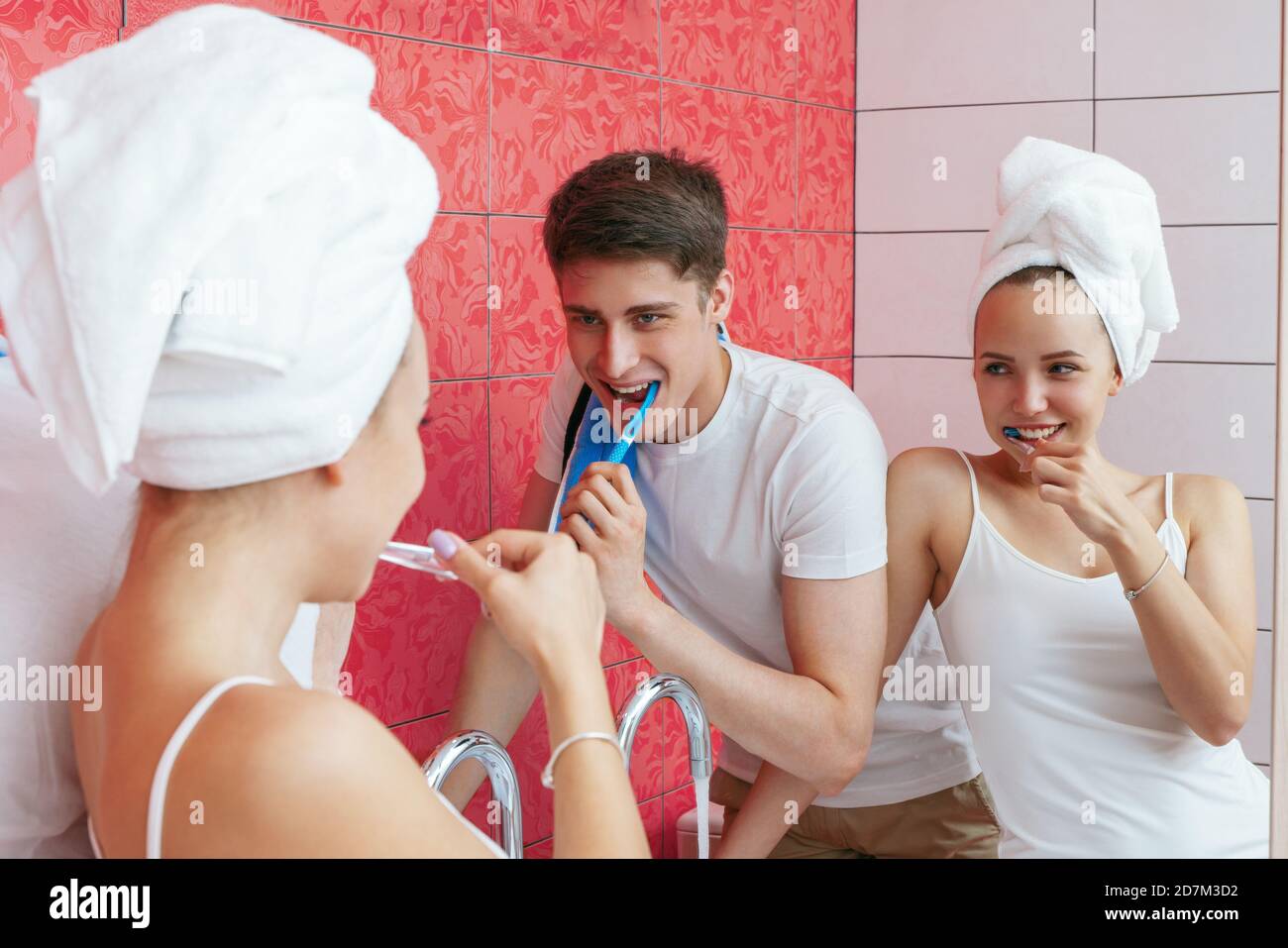 A young couple is brushing teeth. Couple fooling around in the bathroom. Lifestyle photography Stock Photo