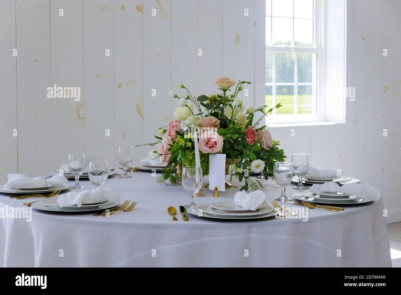 Elegance white table set with flower in restaurant. Stock Photo